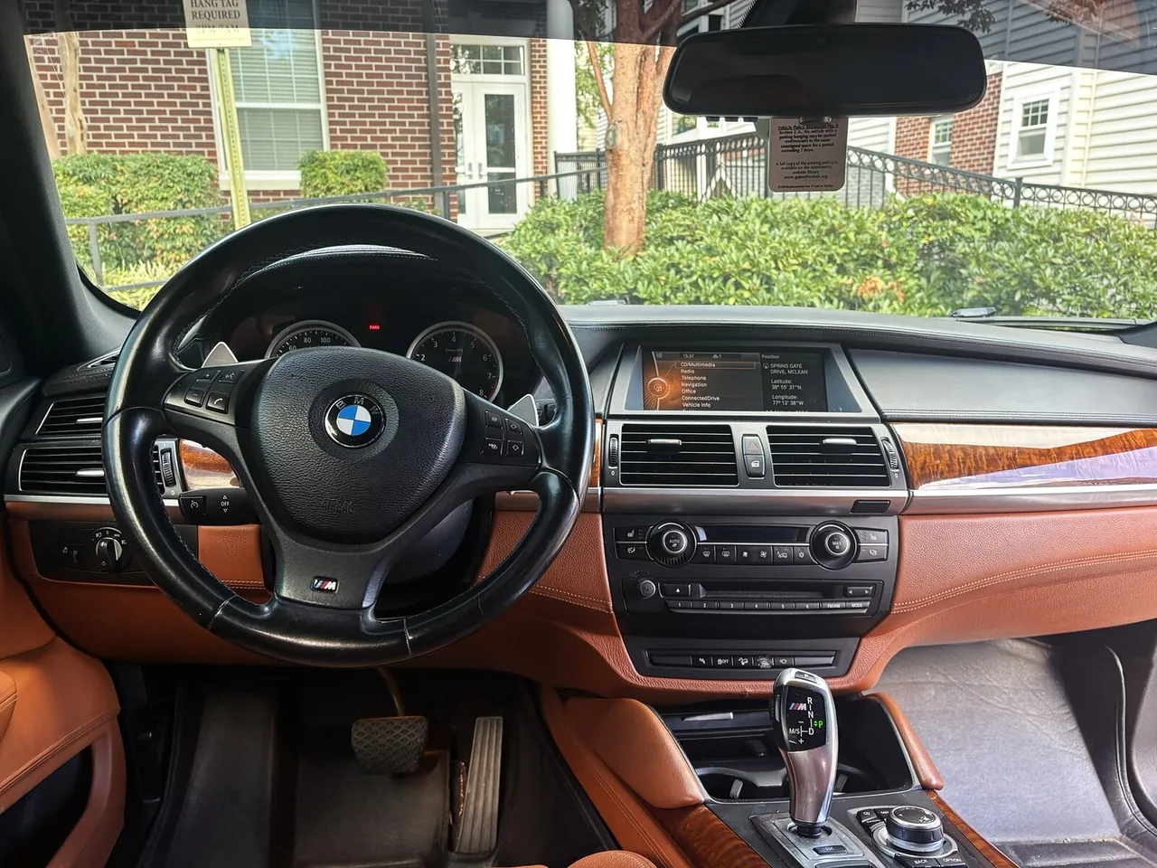 2012 BMW X6 M from the driver's seat before the upgrade, with the original BMW iDrive display